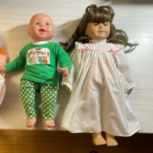 American Girl Doll Samantha (from the 1980s or 90s) plus one other baby doll.